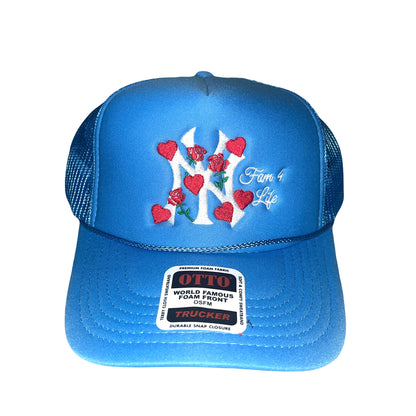 A light blue trucker hat with an embroidered designsurrounded by roses and hearts, and the mantra 'Fam 4 Life.'.